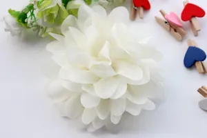 Close-up of white multilayer chiffon fabric flowers for DIY hair accessories and apparel