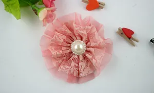 Detail of pink double-layered lace flower with mesh base and pearl centerpiece