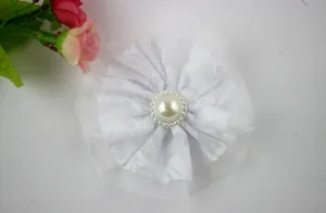 Close-up of white double-layered lace flower with mesh base and central faux pearl