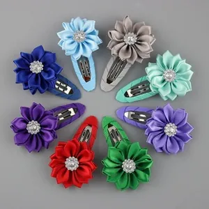 Flat lay of 8-piece chiffon flower hair clip set for girls with rhinestone centers