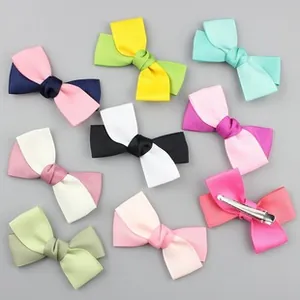 Flat lay of colorful ribbed ribbon bow hair clips with metal alligator duckbill clips