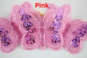 Detailed view of pink embroidered butterfly patch with sequins and mesh fabric