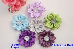 Detail of satin fabric flowers with rhinestone center for DIY hair accessories and crafts