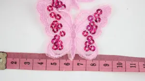 Detailed view showing a 4.5cm pink sequined butterfly patch with embroidery on soft mesh
