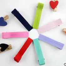 Detailed view of colorful grosgrain ribbon wrapped duckbill clips in seven vibrant shades