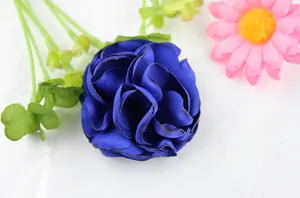 Detailed macro view of dark blue satin fabric flower with burnt edges for DIY accessories