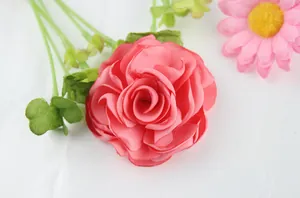 Macro detail of coral pink satin fabric rose flower with burnt edge for DIY crafts
