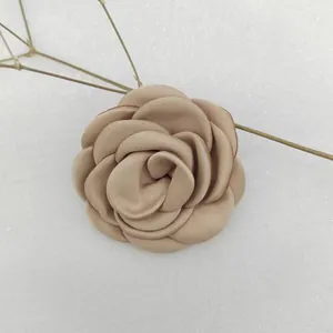 Macro shot of 6cm champagne fabric camellia flower with burnt edges for hair accessories