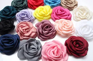 Flat lay of colorful 6cm fabric camellia and rose flowers for DIY hair accessories