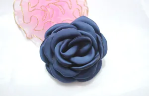 Detailed close-up of a 6cm navy blue fabric camellia flower with layered petals