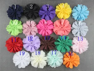 Flat lay of handmade chiffon wavy flowers in 19 colors for DIY hair accessories and decor