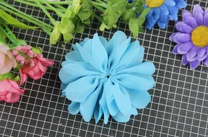 Detailed macro view of sky blue layered chiffon fabric flower for DIY hair accessories