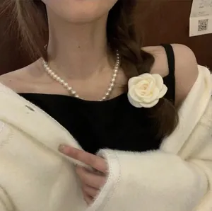 Elegant white camellia flower hair accessory and classic pearl necklace for women
