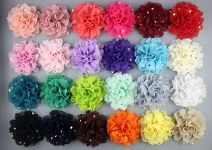 Flat lay of 24 colorful chiffon flowers with gold polka dots for DIY clothing and crafts