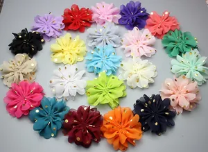 Detailed flat lay of colorful chiffon flowers with gold foil polka dots in various shades