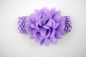 Close-up of a purple chiffon flower on a knitted crochet headband for baby girls
