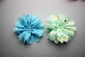 Detailed view of 8cm chiffon flowers with gold polka dots and wavy pleated petal layers