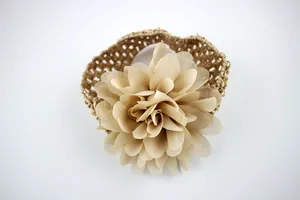 Detail of baby crochet headband with multilayered beige chiffon flower accent