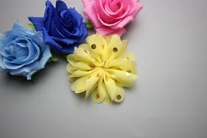 Detailed view of 8cm chiffon flowers with gold polka dots and pleated wavy edges