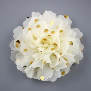 Macro detail of cream chiffon flower with gold polka dots for DIY clothing accessories
