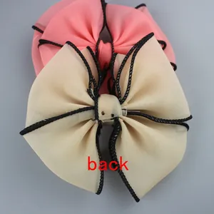 Detail view of the back of large chiffon bow accessories with black woven edging