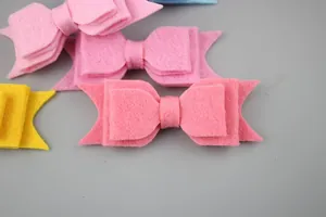 Macro detail of multi-colored non-woven felt bow accessories for DIY baby hair clips
