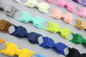 Flat lay of colorful double-layered felt butterfly bows for baby hair accessories