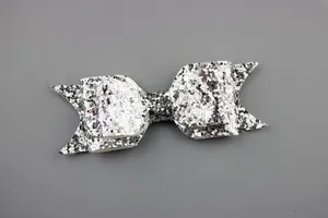 Close-up of a silver glitter double-layer bow hair clip with textured sparkly finish
