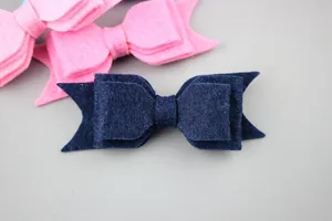 Detailed texture of multilayer felt bow hair clips in navy blue and pink for children