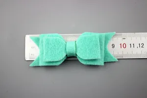 Detailed view of mint green non-woven felt double bow accessory with 8cm measurement guide