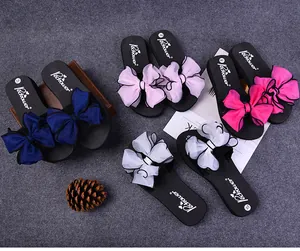 Flat lay of platform slippers featuring oversized layered chiffon bows in multiple colors