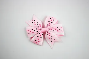 Detailed top view of pink polka dot ribbon bow with delicate white lace edge