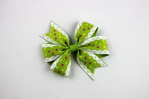 Green grosgrain ribbon bow with yellow and red polka dots and white lace details