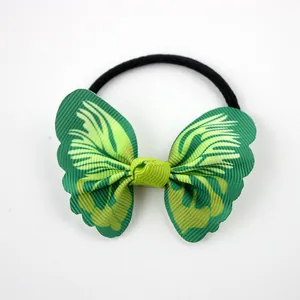 Detail of green ribbed fabric butterfly hair tie with wavy laser-cut edges and elastic band