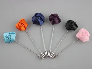 Detail showing various colors of handmade fabric rose lapel pins with metal long needles