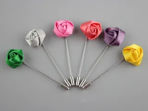Detailed view of handmade fabric rose lapel pins in six vibrant satin finish colors