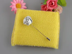 Detail of handmade silver-grey satin rose lapel pin with long metal needle on sponge