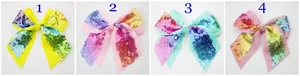 Detail of four colorful sequin bow hair clips with rainbow embroidery for girls