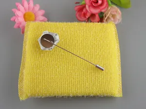 Detail of the silver metal needle and fabric base on a mini rose lapel pin for suits