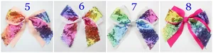 Detail view of four sequined bow hair clips with embroidery and colorful ribbons
