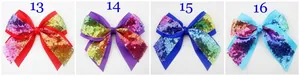 Detail of four girls' ribbon hair clips with colorful sequins in red, purple, and blue