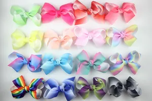 Macro view of 16 colorful rainbow gradient grosgrain ribbon bow hair accessories for kids