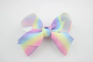 Detail of colorful rainbow gradient hair bow made from textured grosgrain ribbon fabric
