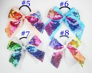 Set of four sequin bow hair ties with glittery textures in pink, blue, and white colors