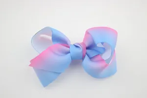 Detailed view of the pink and blue gradient grosgrain texture on a handmade hair bow
