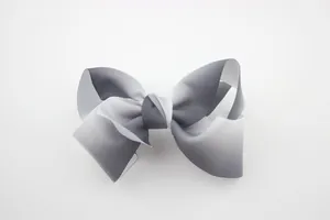 Close-up of a large grey and white gradient grosgrain ribbon bow with fine texture
