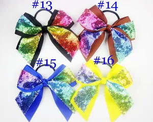 Detail of four sequin bow hair ties with elastic bands in various gradient colors