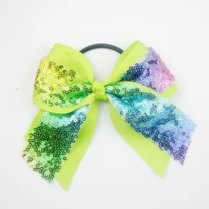 Macro detail of ribbed green ribbon hair bow with gradient sequins and elastic tie