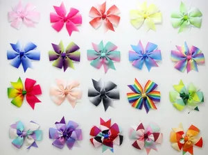 Flat lay of 20 assorted colorful rainbow wave print bow clips for girls hair