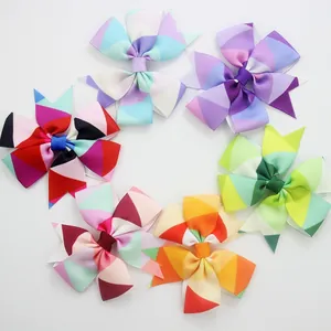 Close-up of six-piece kids bow hair clip set featuring colorful geometric patterns